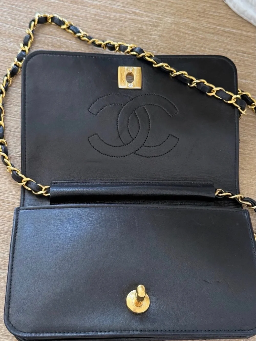 CHANEL Black Quilted Shoulder Bag with Gold Chain and CC Lock